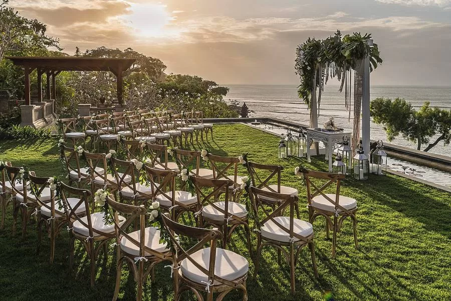 Chairs are arranged and decorated overlooking the ocean as twilight approaches