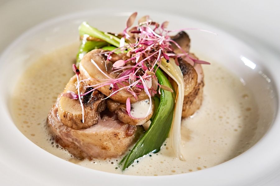 Roasted chicken leg in cauliflower Cappuccino Soup with truffle oil flavor, served by Tirtha Bali, one of the best Bali wedding venues