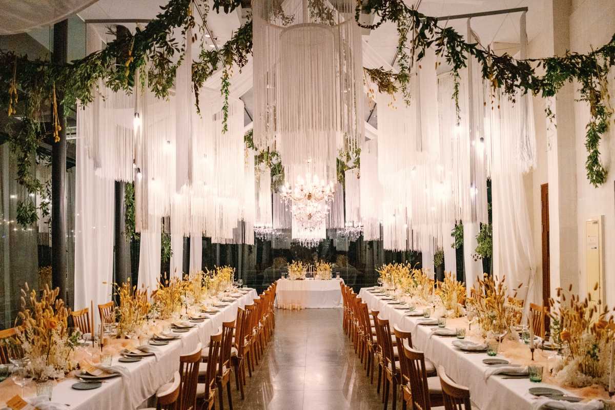 Wave Tassels & Chandeliers with Greenery designed to elevate your wedding venue decoration to a realm of extraordinary luxury