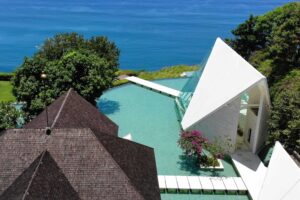 Glass chapel wedding venue in Bali overlooking the ocean at Tirtha Uluwatu.