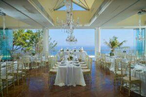 Heaven Room, an ocean view wedding venue, set for a reception with chandeliers.