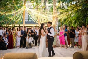 Couple’s first dance surrounded by guests at Moonlight Garden, Tirtha Bali's garden wedding venue.