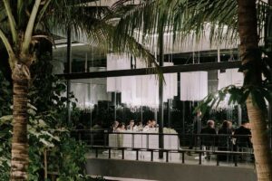 Evening celebration aglow through glass walls at Tirtha Bali’s Plumeria Room.