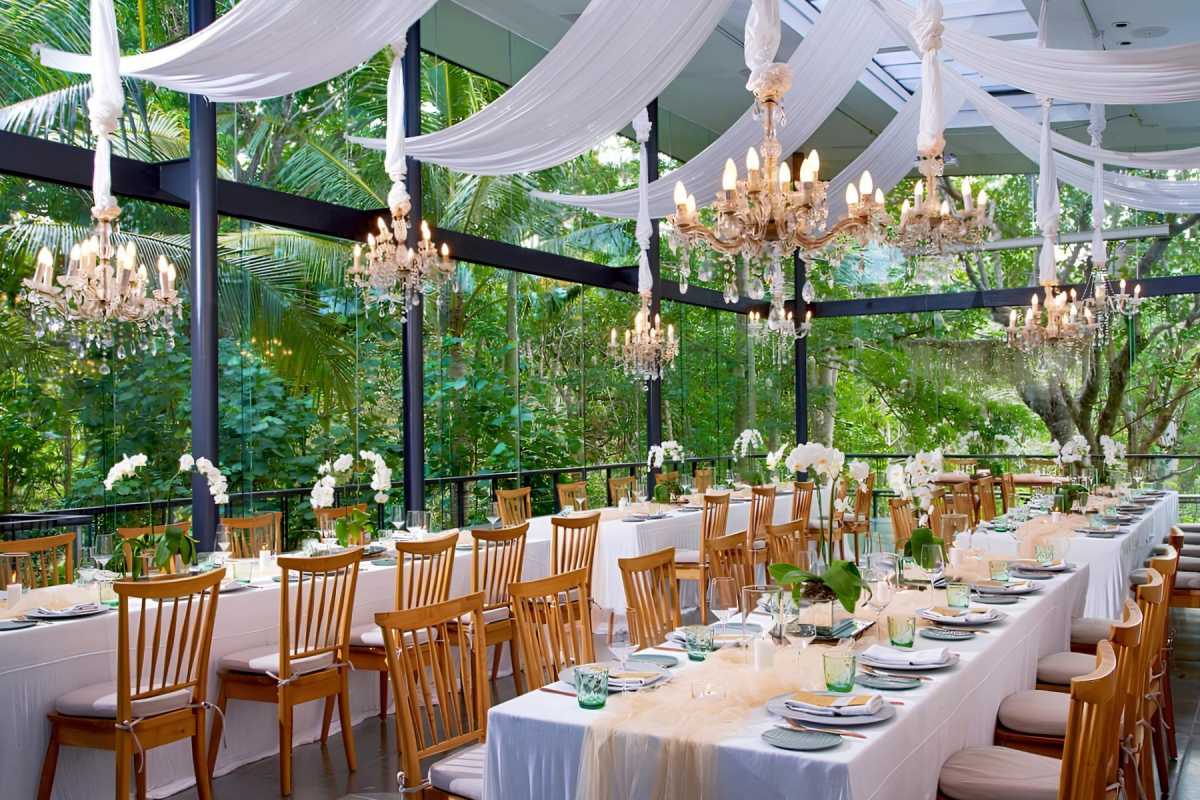 Sunlit wedding reception at Tirtha Bali’s Plumeria Room, a serene greenhouse wedding venue surrounded by nature