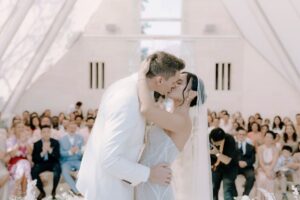 Bride and groom share a kiss inside the wedding chapel at Tirtha Uluwatu, Bali