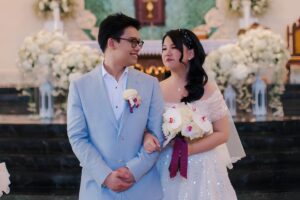 Angela and Vendy share a joyful moment after their Catholic wedding in Bali.