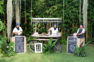 Food cart station with chefs at a garden reception venue by Tirtha Bali.