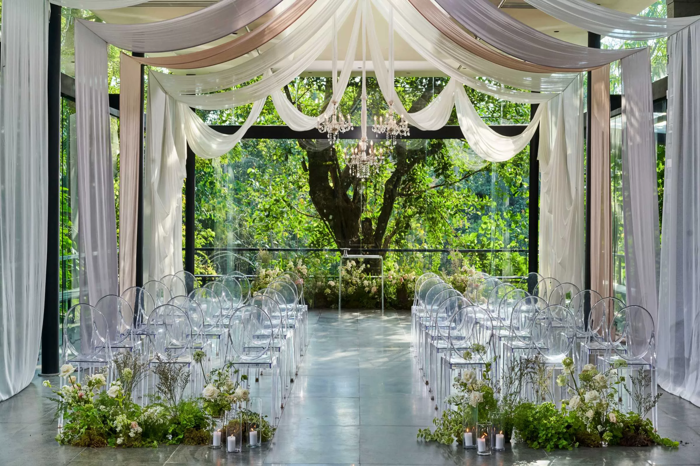 Plumeria Room at the Glass House by Tirtha, included in the Alice wedding package, featuring draped ceiling and floral decor.