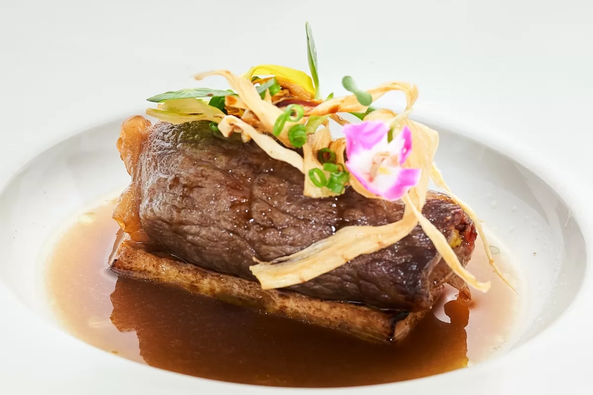 Australian Wagyu beef sukiyaki style with truffle oil, served with garnish and rich sauce.