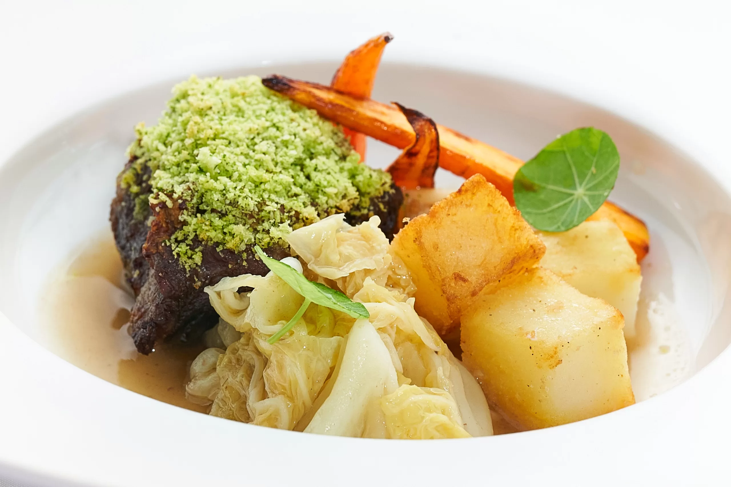 Stewed Australian Wagyu beef cheek with Bintang beer flavor, served with vegetables and sauce.