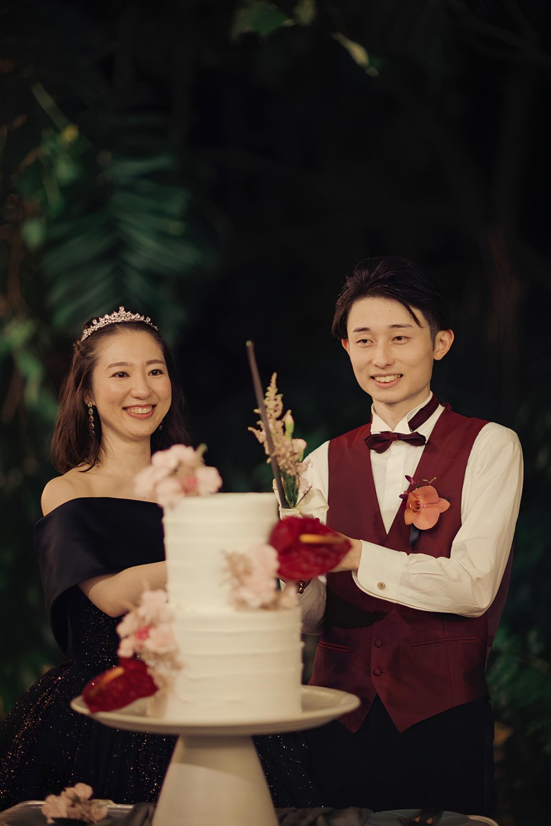 Mina and Taigen cut their wedding cake together during their Bali destination wedding celebration.