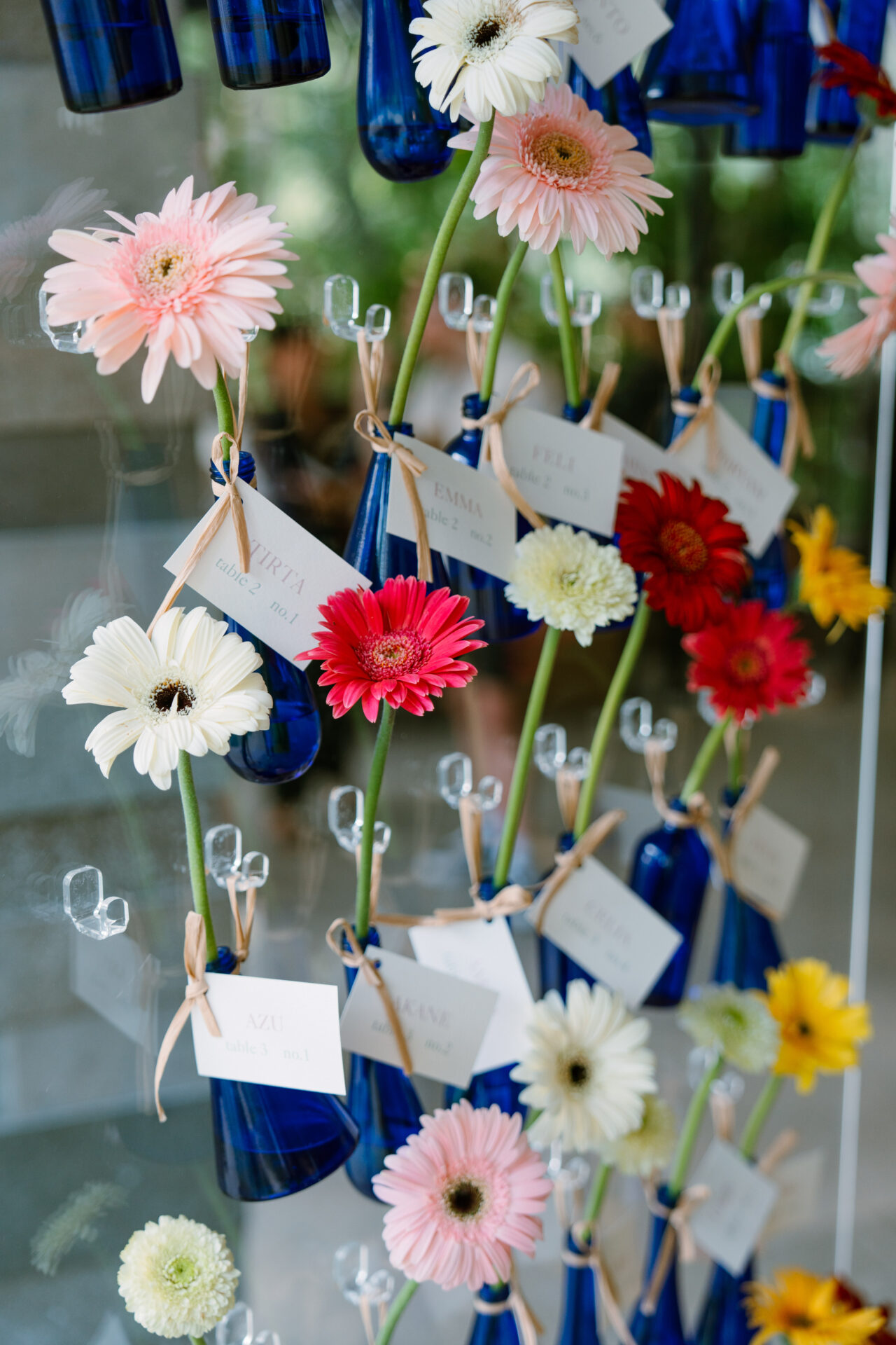 A floral escort card display inviting guests to take home a piece of the celebration.