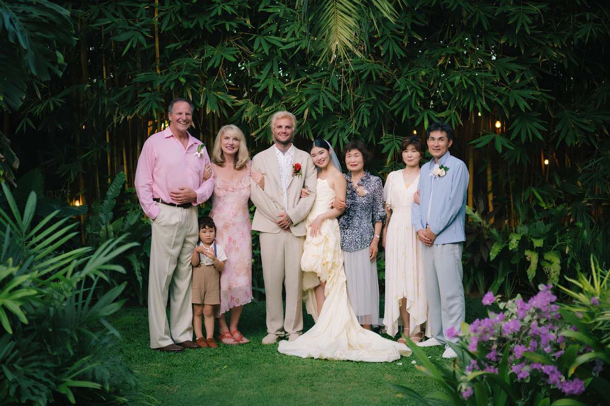 Akari & Michaljon with their families during a group photo session at their multicultural destination wedding at Tirtha Bali.