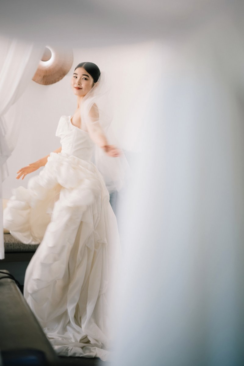 Akari twirls in her gown, a joyful bridal moment during her Bali wedding at Tirtha.