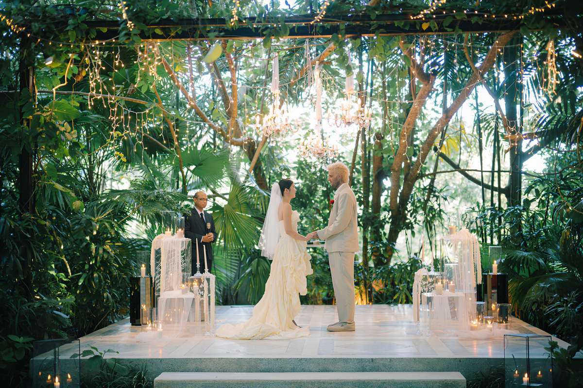 The real wedding couple exchange vows at Moonlight Garden, a garden wedding venue by Tirtha Bali.