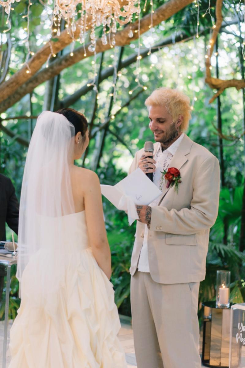 Michaljon reads his vows to Akari at their wedding ceremony in Moonlight Garden, a wedding venue by Tirtha Bali.