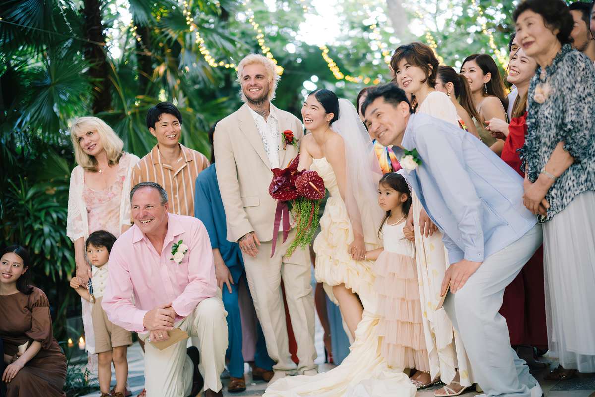 The wedding couple and their loved ones gather for a photo session at destination wedding in Bali with Tirtha.