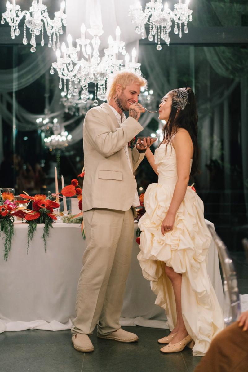 Michaljon gently feeds Akari during their reception at the Plumeria Room by Tirtha Bali.