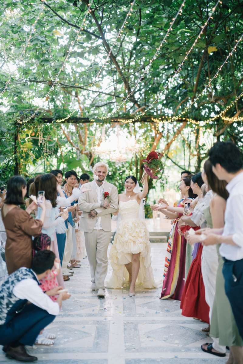 The real wedding couple celebrate their joyful ceremony exit at Tirtha, surrounded by loved ones.