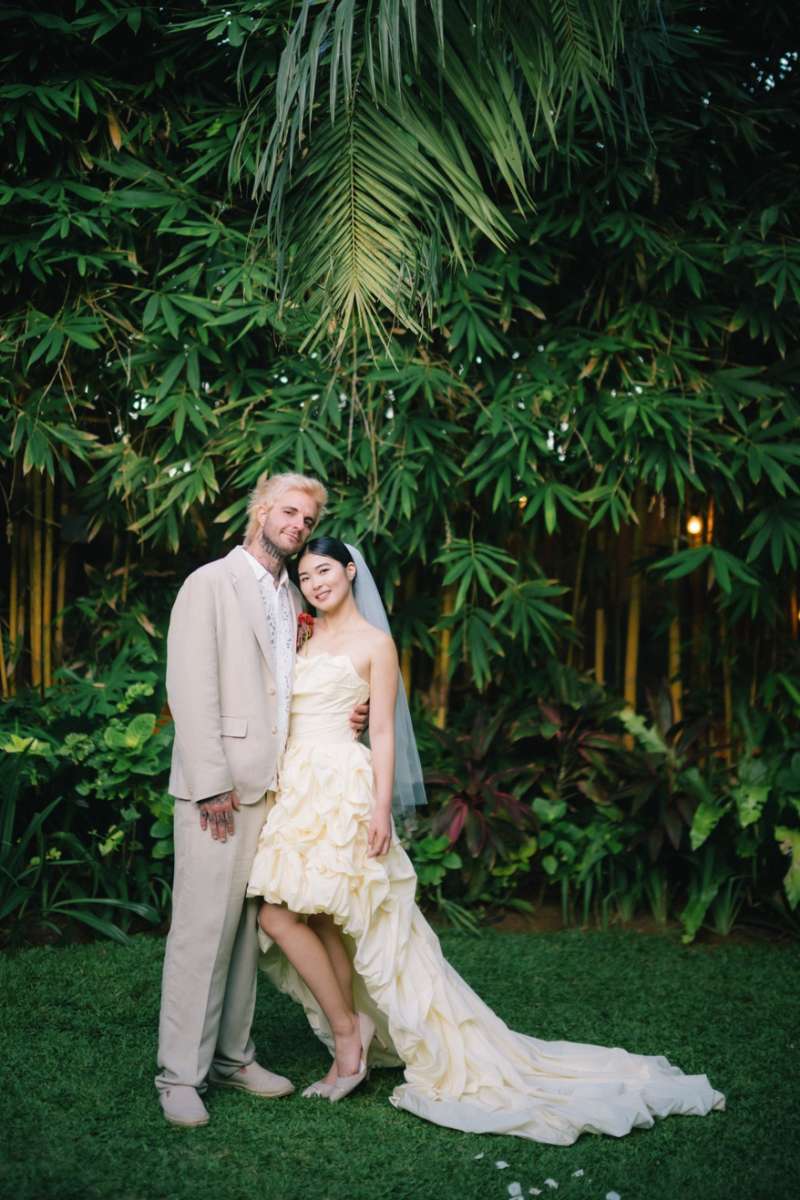 Akari & Michaljon pose for a couple portrait in the garden of the Glass House by Tirtha, a wedding venue in Bali.