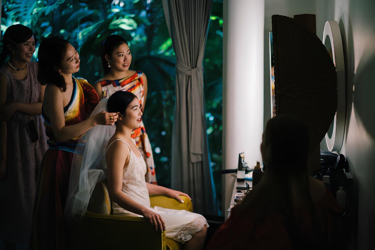 Akari surrounded by her bridesmaids in a joyful morning preparation moment at the Glass House.