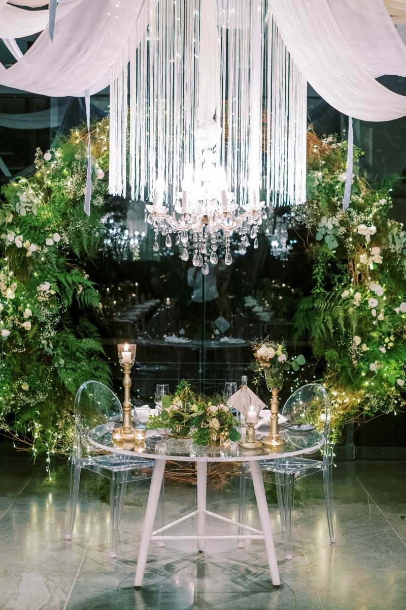 Candlelit floral centerpiece in the Plumeria Room with gold accents.