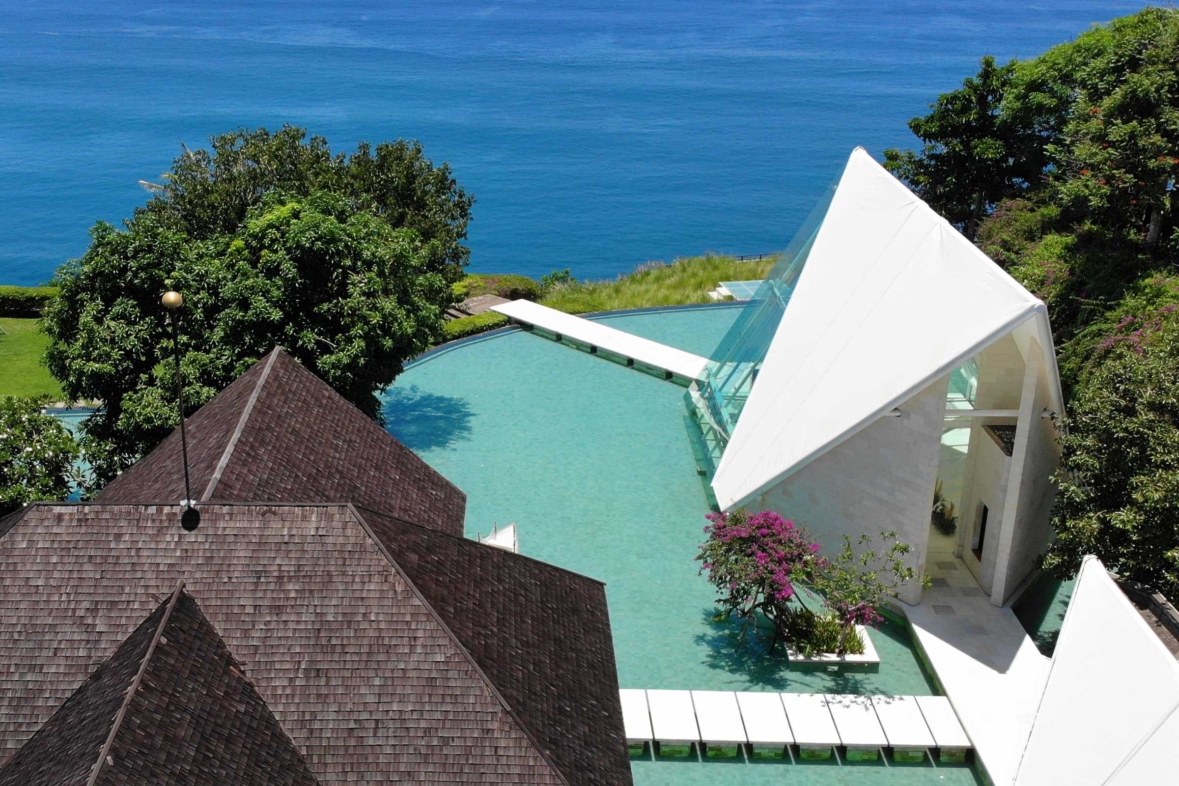 Glass chapel wedding venue in Bali overlooking the ocean at Tirtha Uluwatu.