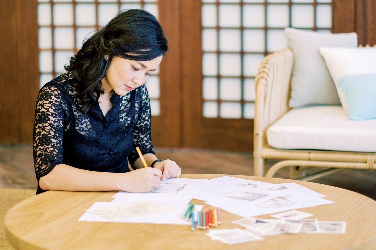 Designer sketching ideas during a Bali wedding planning session at Tirtha.