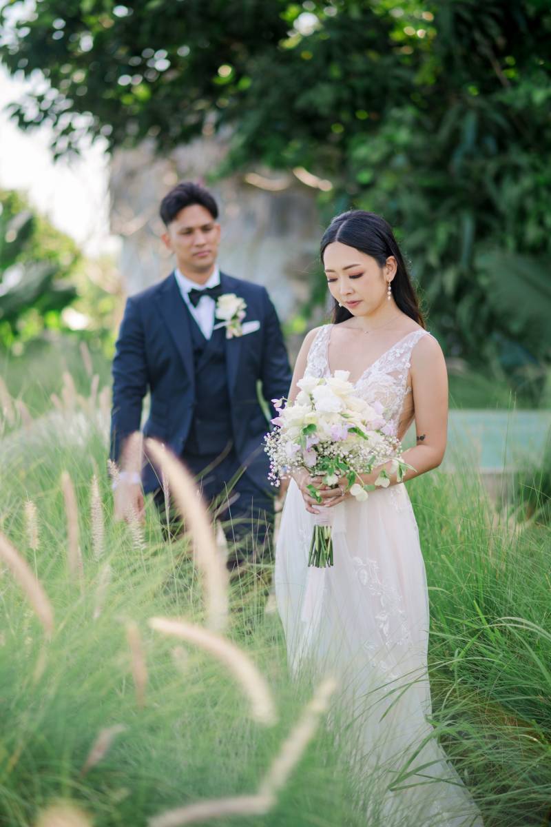 Couple captured in a quiet moment amid lush greenery at Tirtha Uluwatu.
