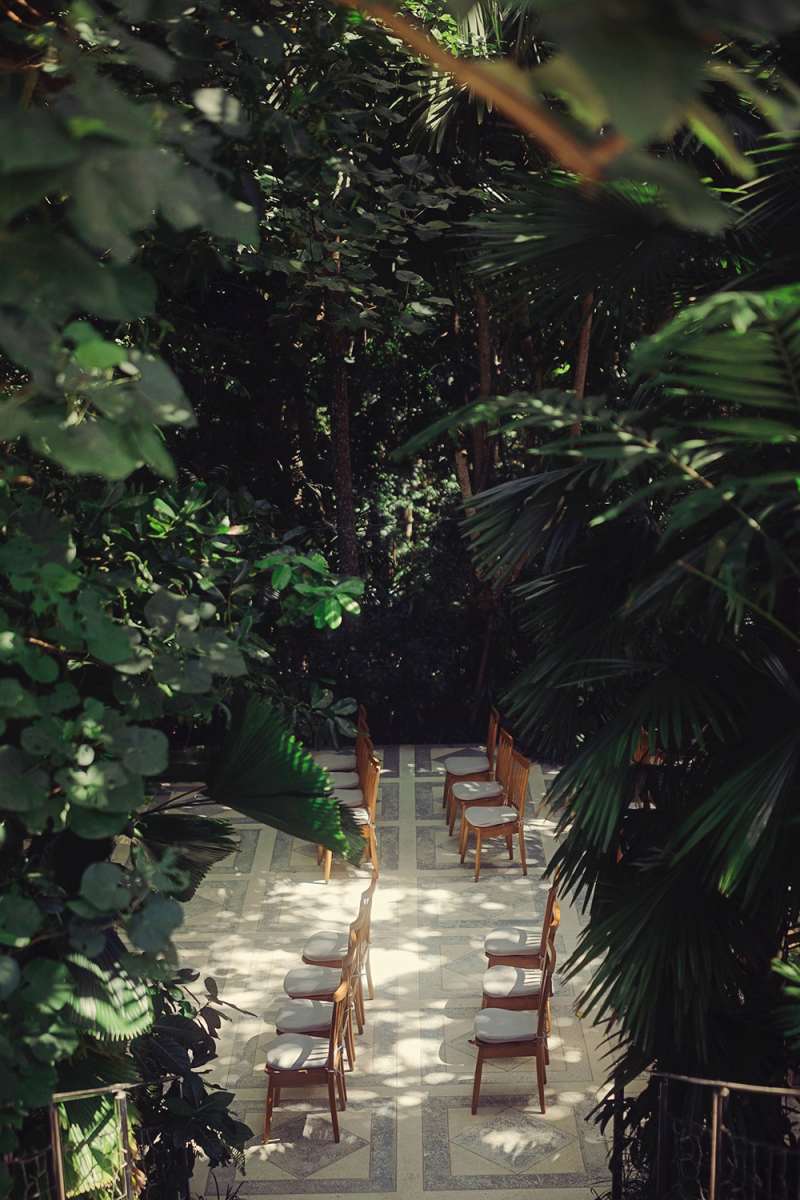 Ceremony seating surrounded by tropical greenery at Tirtha Bali’s lush garden wedding venue.