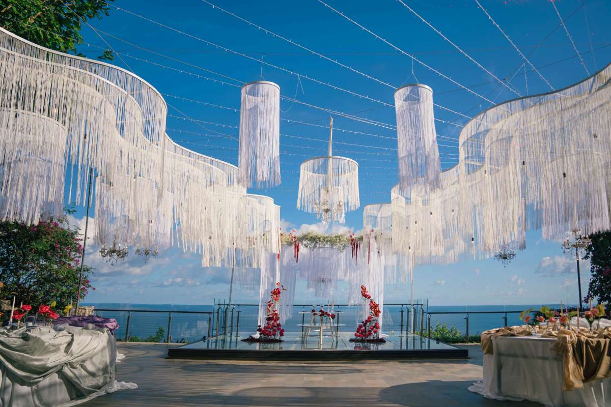 Decorated Glass Stage at Tirtha Uluwatu, a Bali clifftop wedding venue with panoramic ocean views.