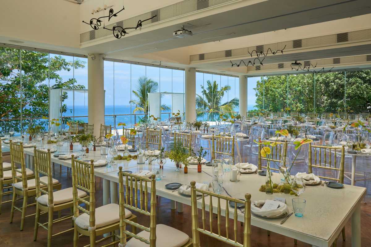 Heaven Room wedding reception setup with gold chairs, tropical florals, and ocean view.