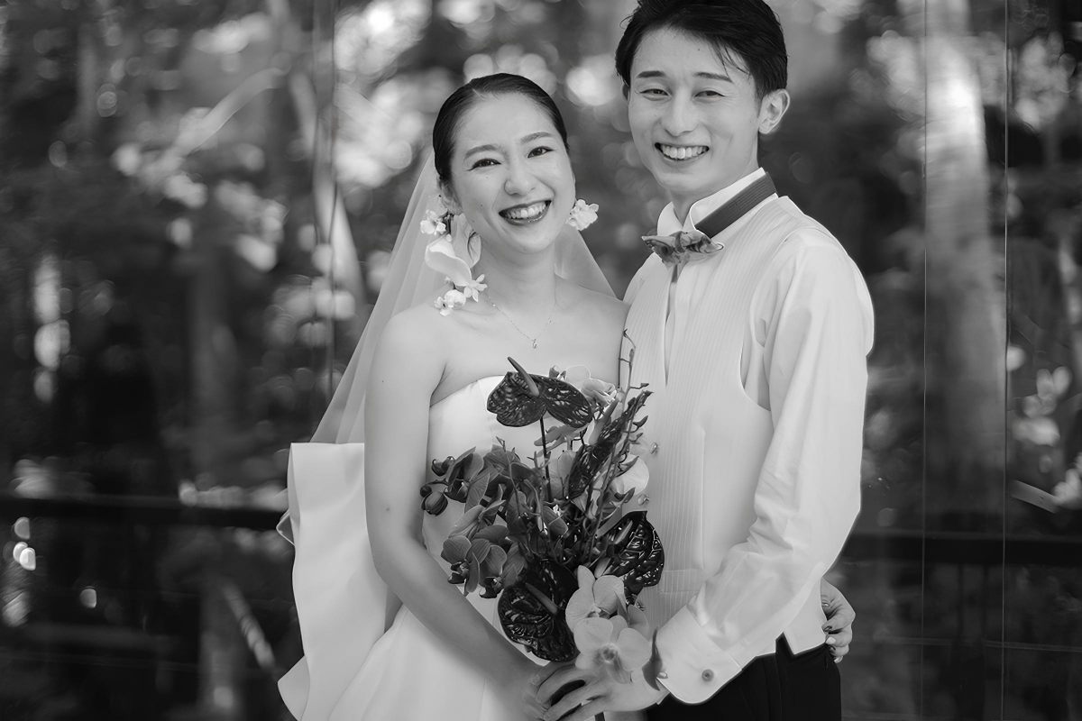 A timeless black-and-white photo of the couple smiling during their Bali destination wedding.