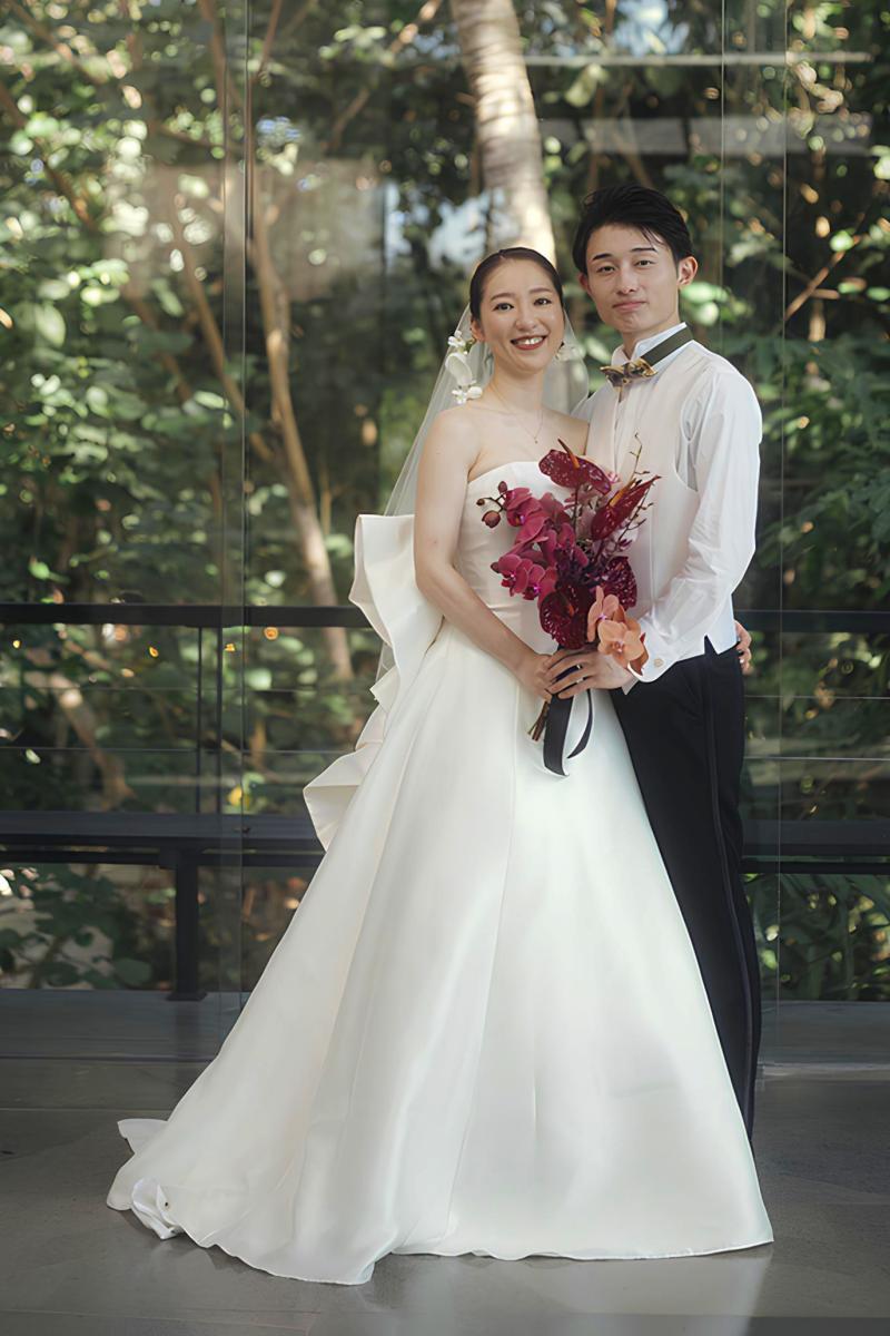 The bride and groom pose in elegant wedding attire at Tirtha Bali wedding venue.