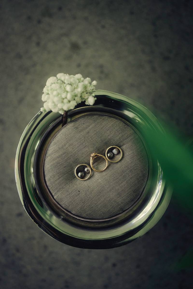 Wedding rings presented with baby’s breath flowers.
