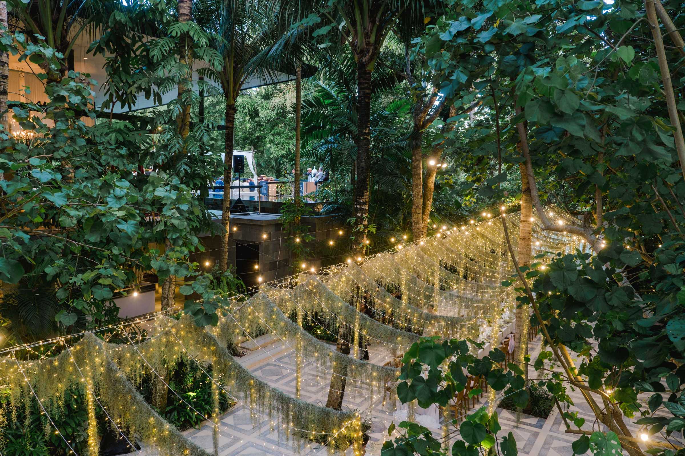 Fairy lights and tropical trees at Moonlight Garden, Tirtha Bali's garden wedding venue.