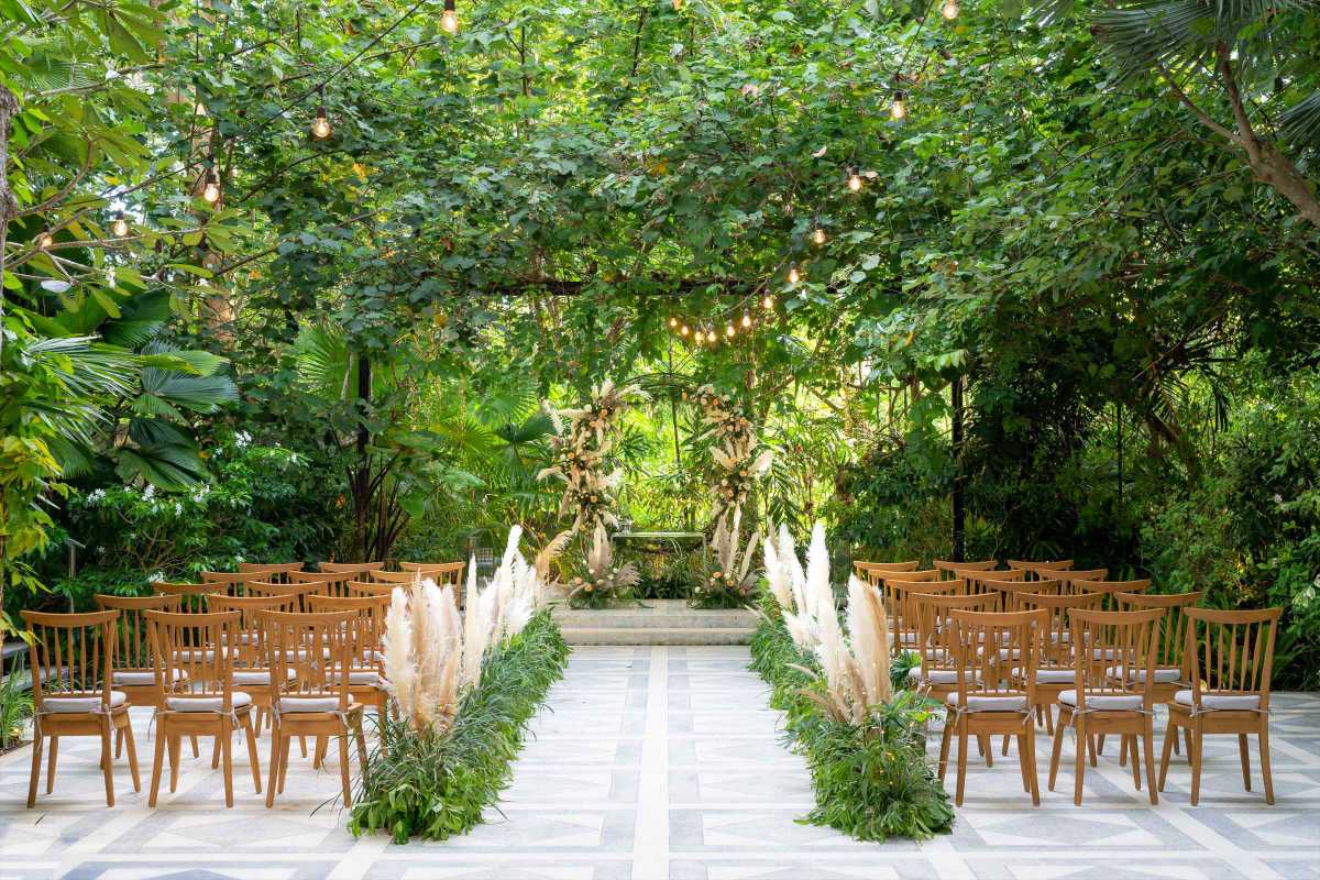 Ceremony setup surrounded by greenery at Tirtha Bali’s Moonlight Garden, a serene garden wedding venue.