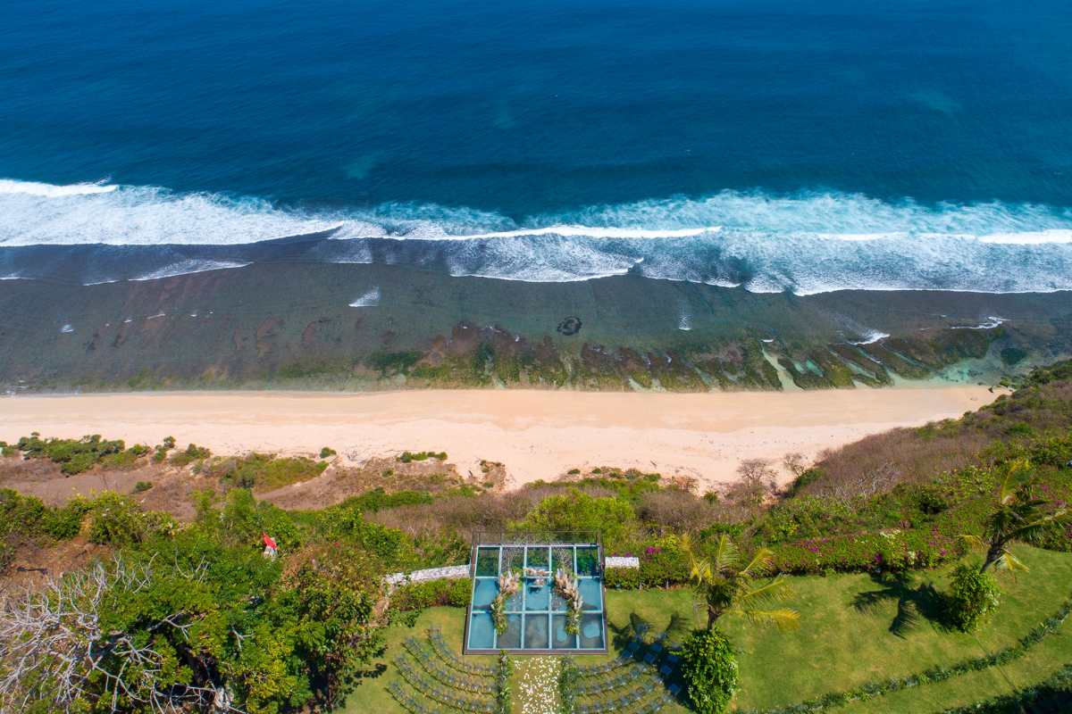 Aerial view of clifftop venue at Tirtha Uluwatu overlooking the beach and ocean.