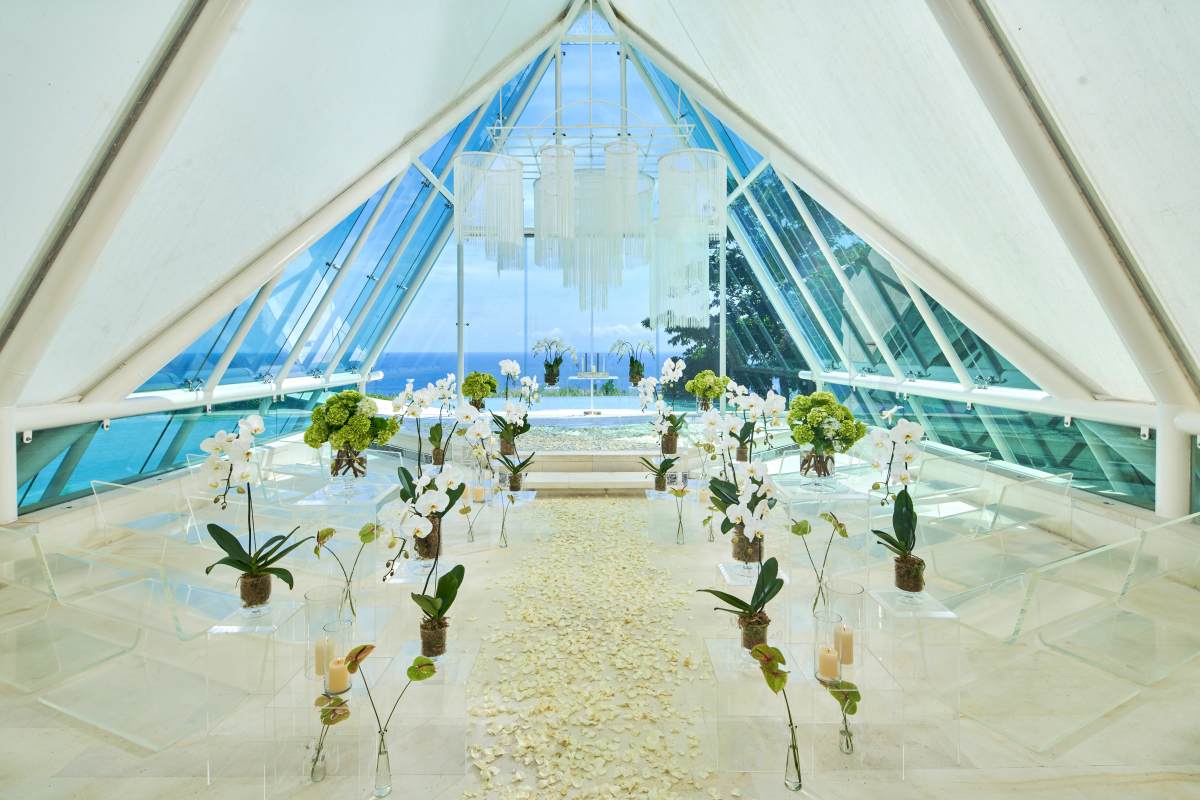 Chapel wedding ceremony setup inside glass chapel at Tirtha Uluwatu Bali.