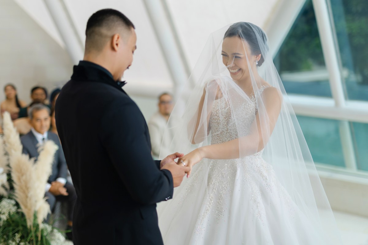 Joyful vow exchange inside the iconic glass chapel at Tirtha Uluwatu.