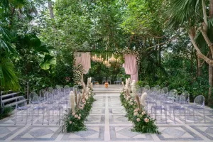 Indian Hindu wedding ceremony setup at the Moonlight Garden with floral aisle decor, mandap, and clear chairs.