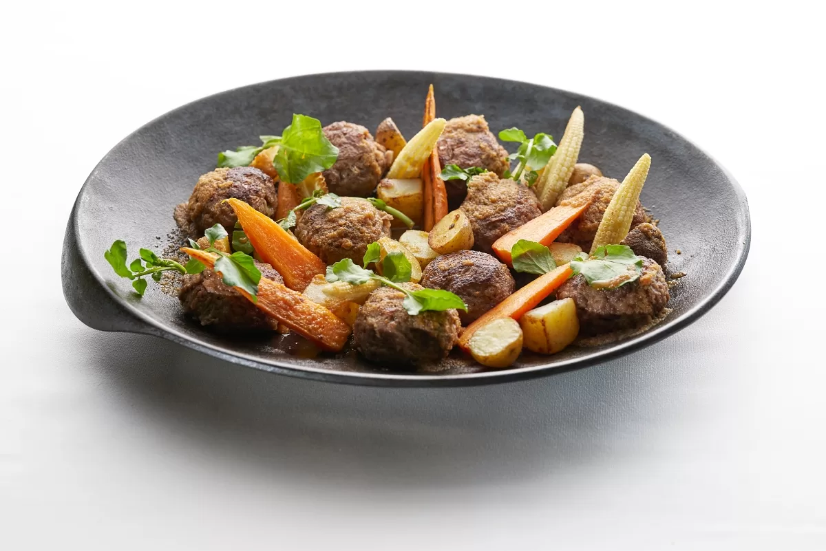 Japanese hamburg steak with beef patties, carrots, baby corn, and potatoes in grated daikon sauce.