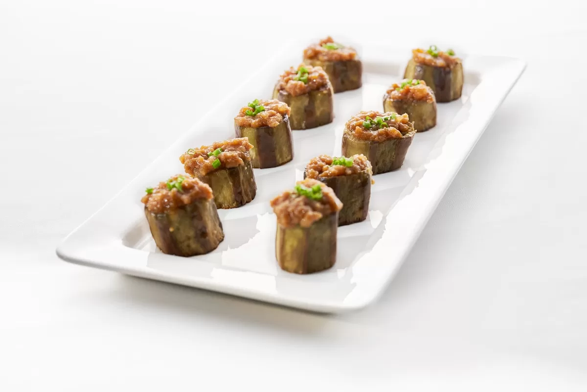 Nasu dengaku with grilled eggplant topped with savory miso meat sauce and chopped green onions.