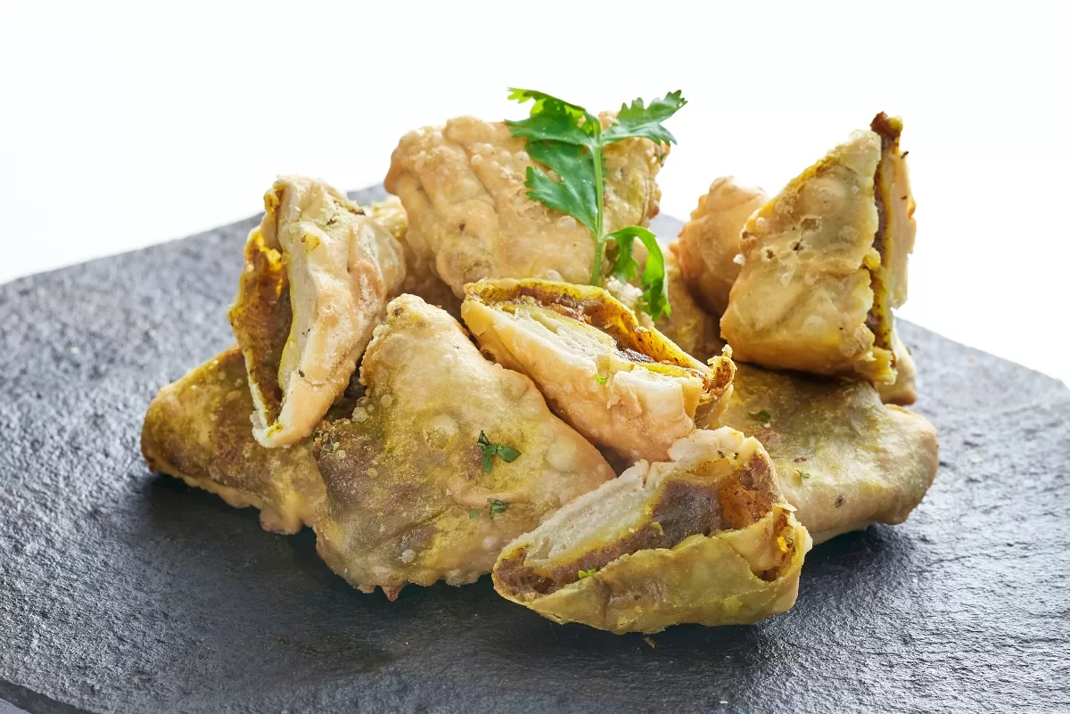 Pakoda served crispy and golden, with spiced filling and cilantro on top.