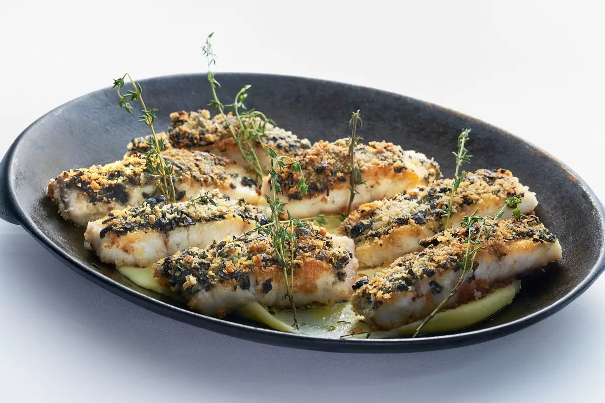 Pan fried barramundi with crispy skin, served on mashed potatoes and garnished with thyme.