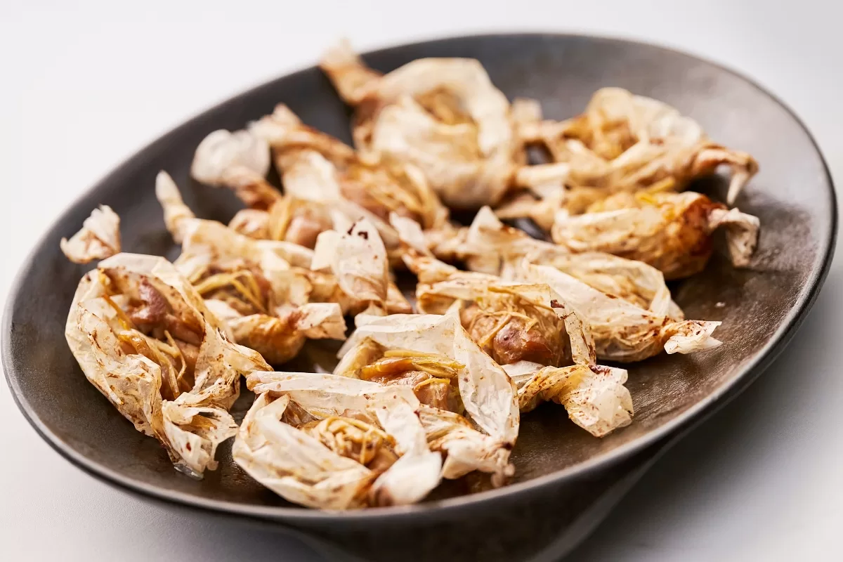 Paper chicken with baked chicken wrapped in baking paper and coated in oyster sauce.