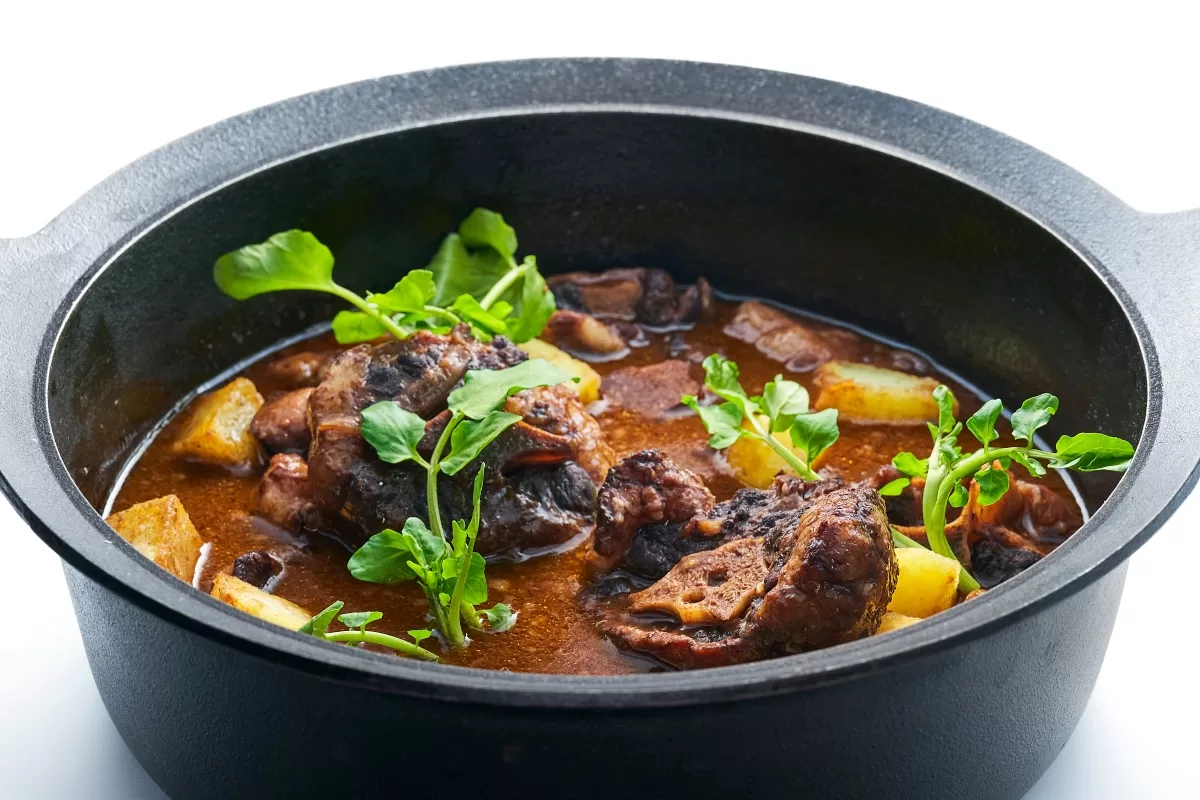 Rabo de toro, Spanish-style stewed oxtail in a rich brown red wine sauce with vegetables.
