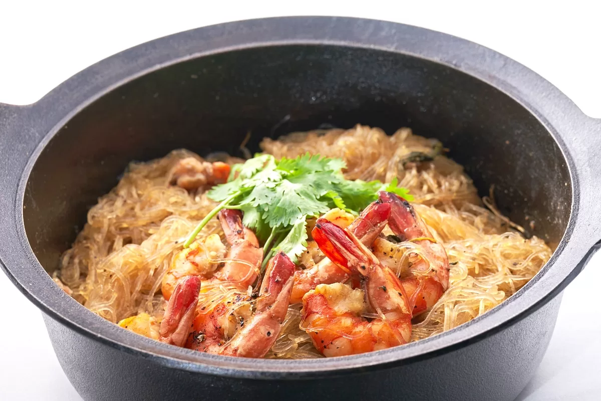 Steamed prawn noodles with glass noodles and shrimp, garnished with cilantro.